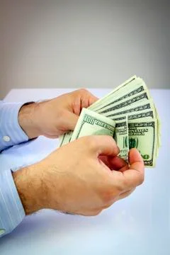 Dollars in hand Stock Photos