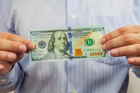Dollars in hand Stock Photos