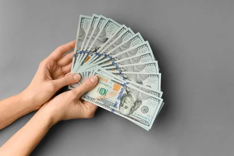 Dollars in hands on grey background top view copy space Stock Photos