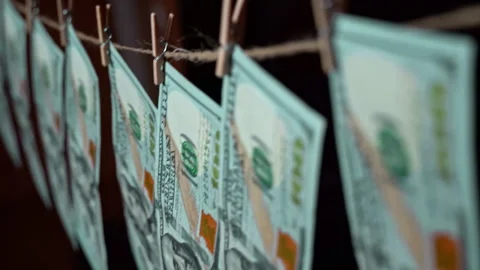 Dollars Hang on a Clothespin Against the Background of Cryptocurrency Chart Stock Footage 260476848