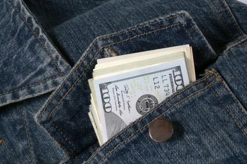 Dollars in jacket pockets Stock Photos