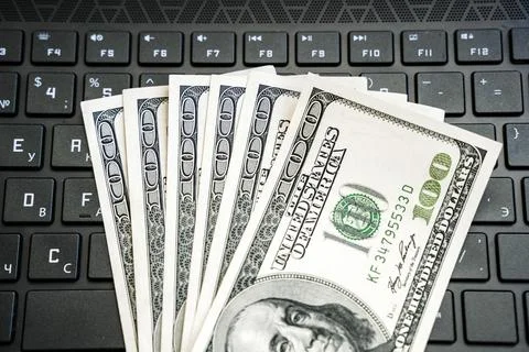 Dollars on keyboard computer. Money in internet and earnings concept Stock Photos