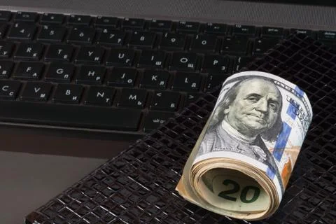 Dollars, laptop and notebook Stock Photos