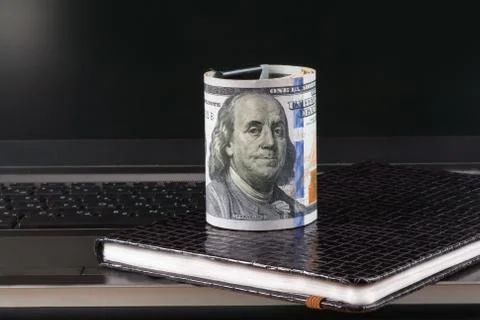 Dollars, laptop and notebook Stock Photos