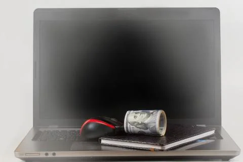 Dollars, laptop and notebook Stock Photos