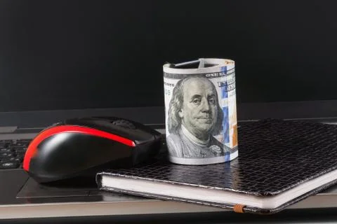 Dollars, laptop and notebook Stock Photos
