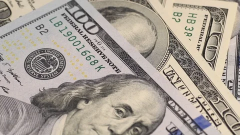 Dollars on laptop keyboard Stock Footage 107516939