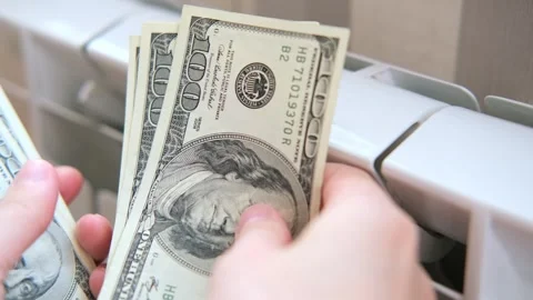 Dollars money banknotes are on heating radiator battery. Concept of expensive Stock Footage 273261237