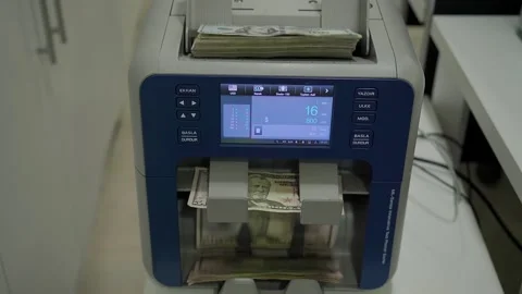 Dollars in money counting machine standing on white table Stock Footage 145198061