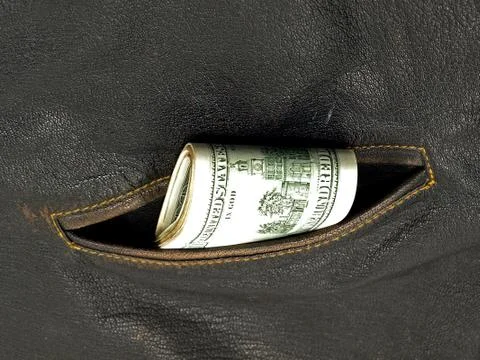 Dollars pack in a pocket. Stock Photos