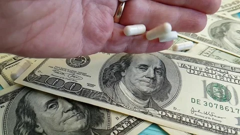 Dollars pill slow-motion shot Stock Footage 90040189