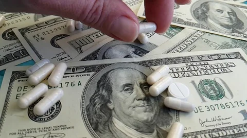 Dollars pills hand slow-motion shot Stock Footage 90039951