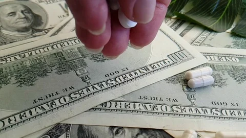 Dollars pills hand slow-motion shot Stock Footage 90040261