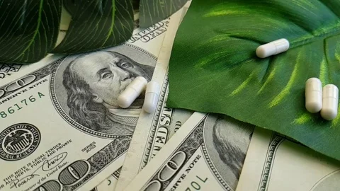 Dollars pills hand slow-motion shot Stock Footage 90040538