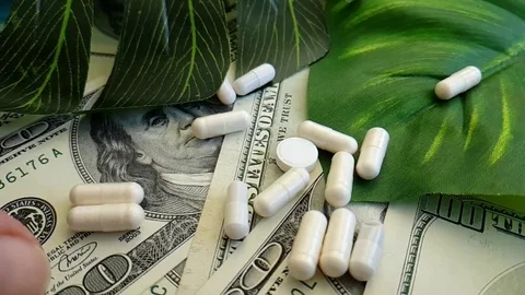 Dollars pills hand slow-motion shot Stock Footage 90040740