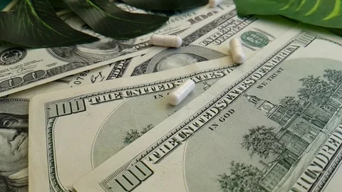 Dollars pills hand slow-motion shot Stock Footage 90041059