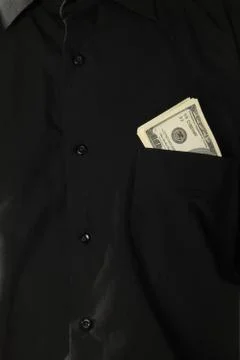Dollars in pocket of coat Stock Photos