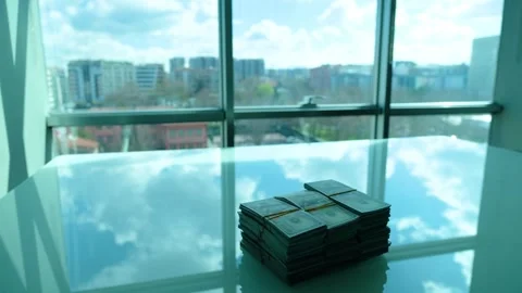 Dollars standing on white table and fast flowing clouds Stock-Footage 270153739