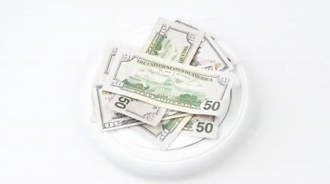 Dollars turning against white background Stock Footage