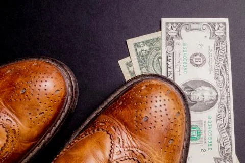 Dollars under a pair of Shoes Stock Photos
