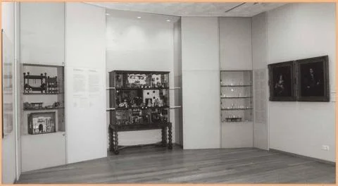 Dollhouse between two showcases with different objects from doll houses; S... Stock Photos