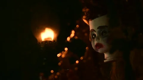 Doll's head turns, the light of the flame is reflected in the old mirror Stock Footage 135387895