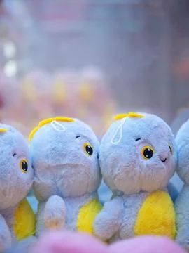 Dolls piled up in claw crane machine inside a local mall Stock Photos