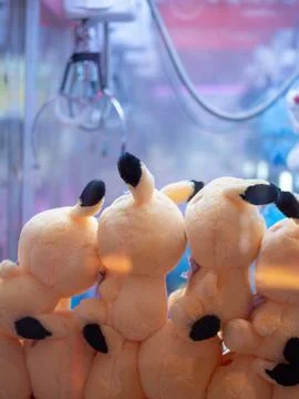 Dolls piled up in claw crane machine inside a local mall Stock Photos