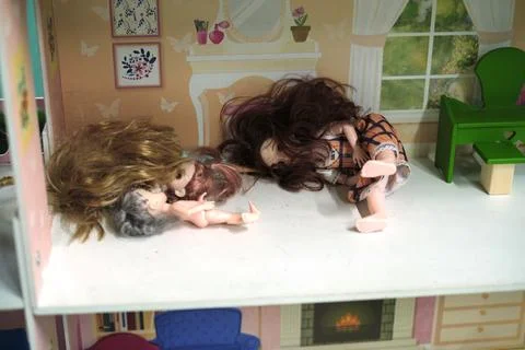Dolls in a playhouse lie in disarray, reflecting a child's room after play. This 스톡 사진