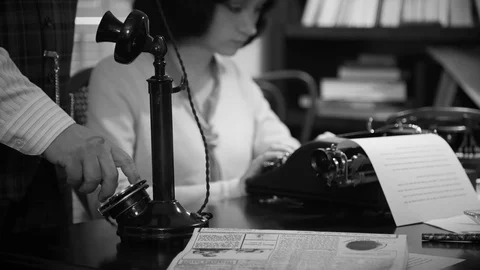 Dolly 1940s man dialing on a candlestick phone Stock Footage 90684547