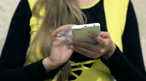 Dolly abstract Hands of a young Girl using a Smartphone Stock Footage