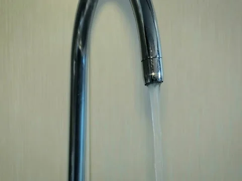 Dolly abstract large jet flowing out of a tap. 4K. Video stock 80534327