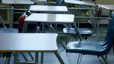 Dolly across empty chairs in School classroom ending on calculator Stock Footage 281858942