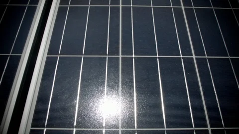 Dolly across solar panel with sun reflection Stock Footage 125475614