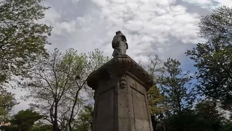 Dolly around statue with stone base Stock Footage 235362585