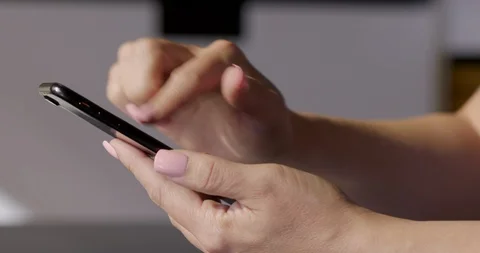 Dolly around woman's hand using a cellphone 4K Stock Footage 86293722