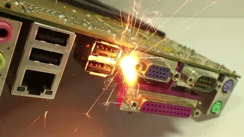 Dolly back and forth near sparking computer component Stock Footage 76453066