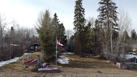 Dolly Back from Canada Flag in front of Cottage Stock Footage 151721122