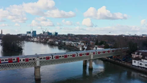 Dolly back drone shot of District line London underground train on Kew Vidéo 148610613