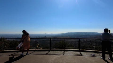 Dolly in between two people towards outlook over valley Stock Footage 143427387