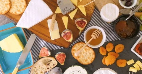 Dolly bird eye view of an assortment of French and British cheese Stock Footage 71846448