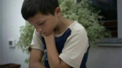 Dolly from boy reading into book Stock Footage 78930045