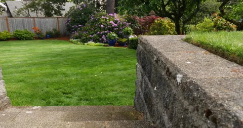 Dolly camera move of stone stairs in beautifully landscaped back yard. Stock Footage 131484291