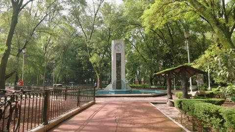 Dolly in, clock tower at Parque Mexico, Mexico City, Mexico - July 9, 2026 Stock Footage 341901931