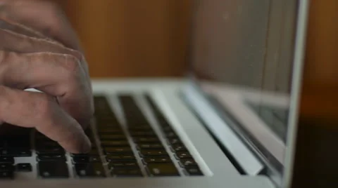 Dolly close up of man typing on laptop computer keyboard Stock Footage 65338347