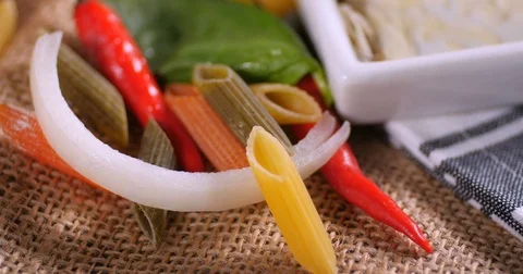 Dolly close up push out view of  Italian pasta and ingredients for tomato sauce Stock Footage 72177907
