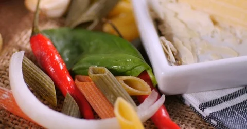 Dolly close up push out view of  Italian pasta and ingredients for tomato sauce Stock Footage 72617379