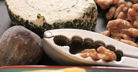 Dolly close up push out view of an assortment of French and British cheese Stock Footage 72617848