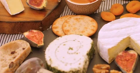 Dolly close up push out view of an assortment of French and British cheese Stock Footage 73132021