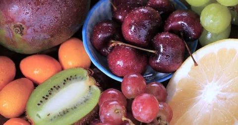 Dolly close up push in view of an assortment of fresh, healthy, organic fruits Stock Footage 72176719
